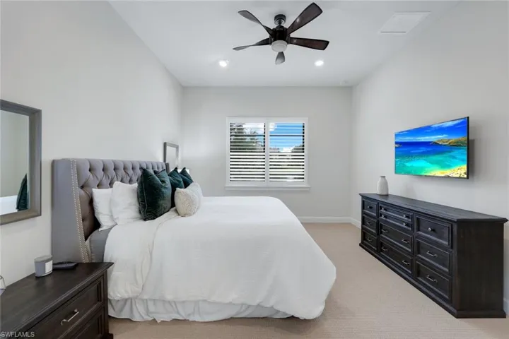 Bedroom featuring ceiling fan and carpet flooring