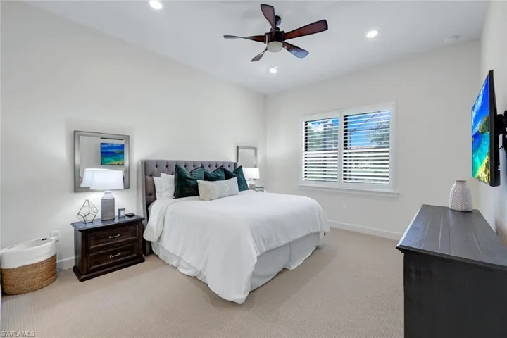 Carpeted bedroom with ceiling fan