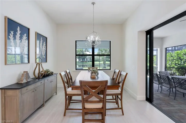 Dining space featuring plenty of natural light and an inviting chandelier