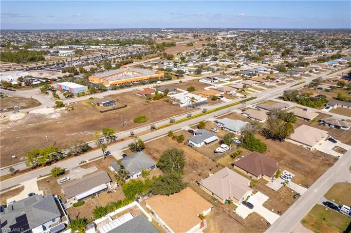 Aerial view of property's location featuring nearby suburban area
