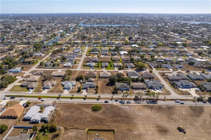 Aerial overview of property's location featuring nearby suburban area