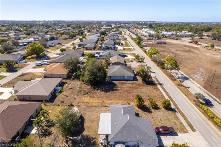 Aerial view of property's location with nearby suburban area