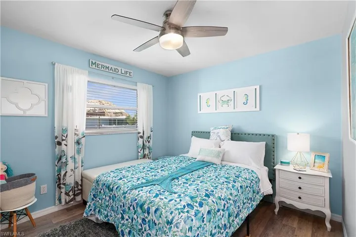Bedroom featuring ceiling fan and dark wood-type flooring