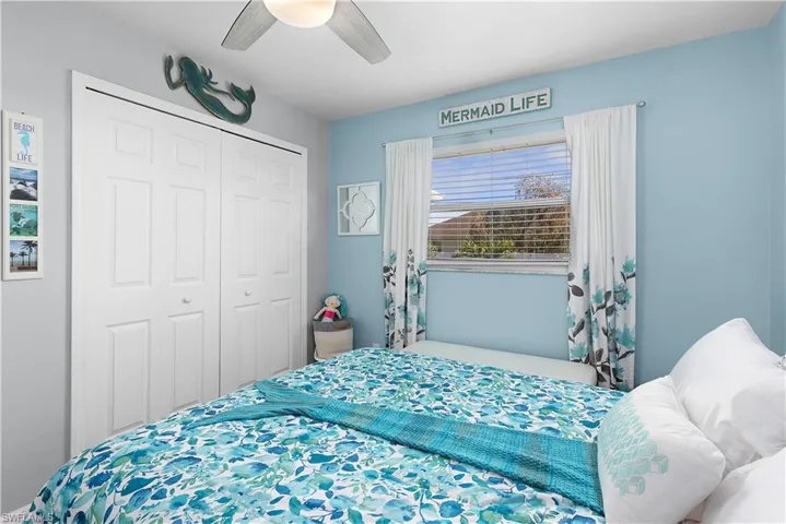 Bedroom featuring ceiling fan and a closet