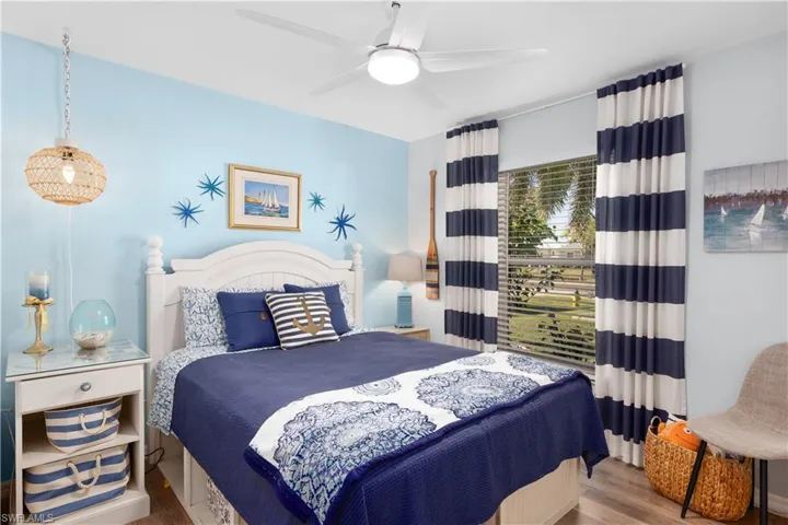 Bedroom with ceiling fan and hardwood / wood-style floors