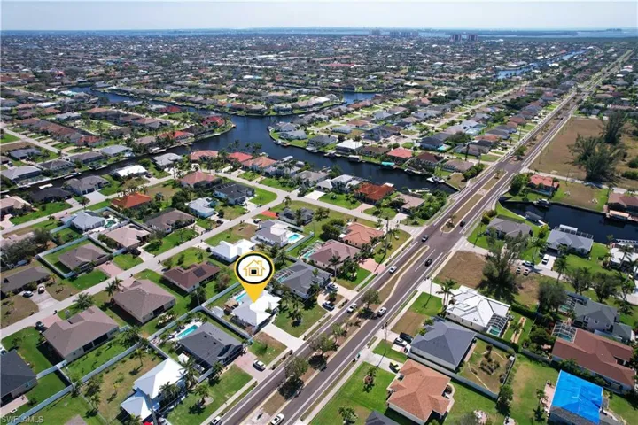 Birds eye view of property with a water view