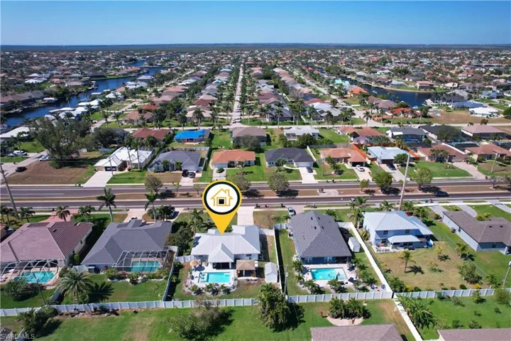 Birds eye view of property with a water view