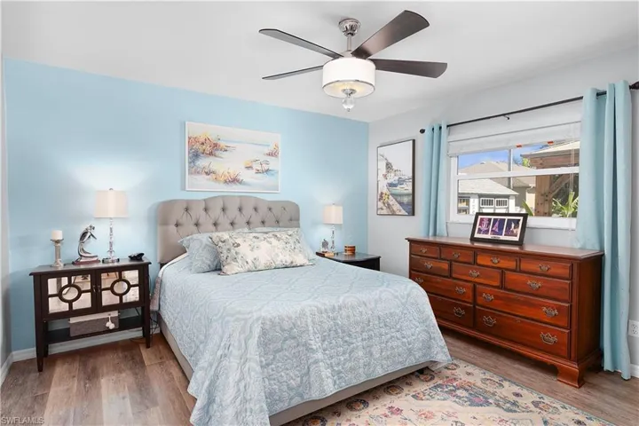Bedroom with ceiling fan and light wood-type flooring