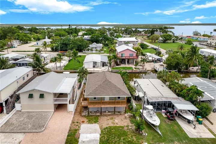 Aerial view of residential area featuring a nearby body of water
