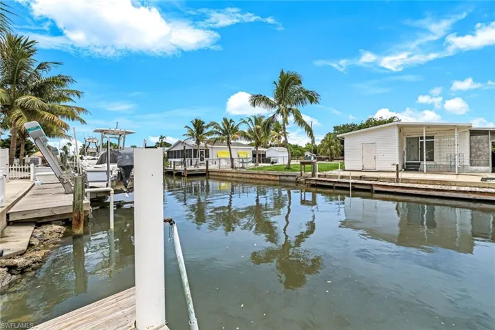 Dock area featuring boat lift and a water view