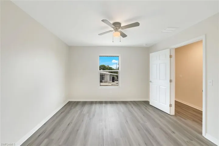 Unfurnished bedroom with light wood finished floors and a ceiling fan
