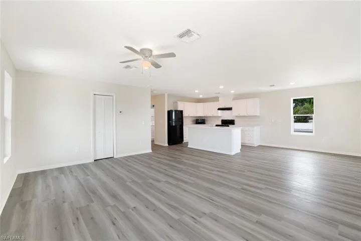 Unfurnished living room featuring a ceiling fan, recessed lighting, and light wood finished floors