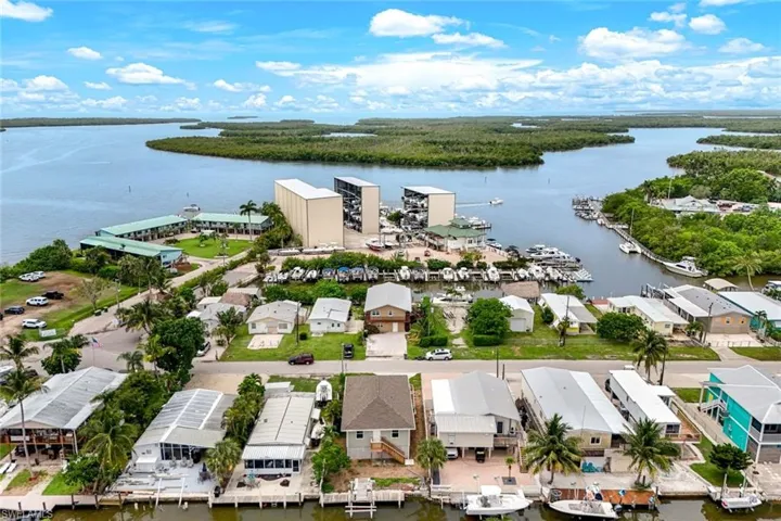 Aerial view of residential area featuring a nearby body of water