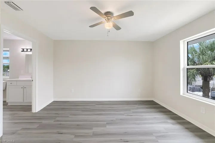 Unfurnished room with ceiling fan and light wood finished floors