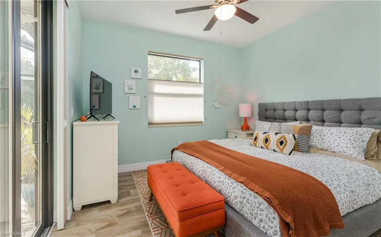 Bedroom with wood finished floors and ceiling fan
