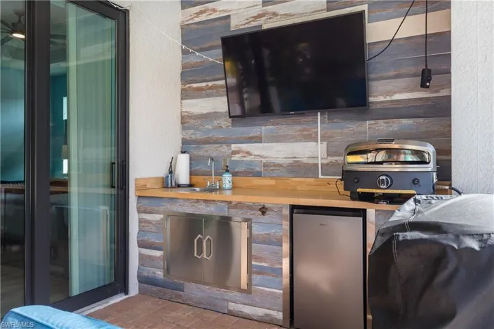 View of patio / terrace with exterior kitchen and a sink