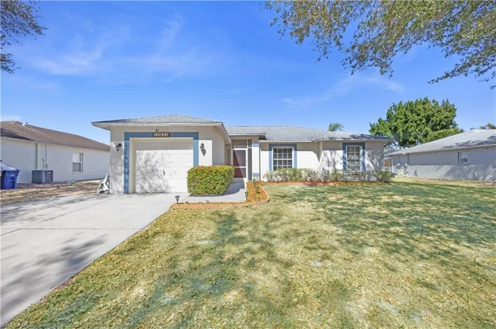 Ranch-style home with stucco siding, driveway, a front lawn, and a garage