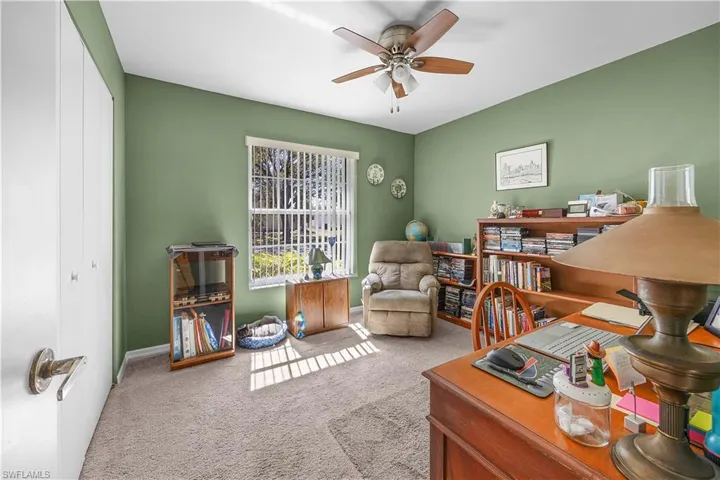 Home office with carpet and a ceiling fan