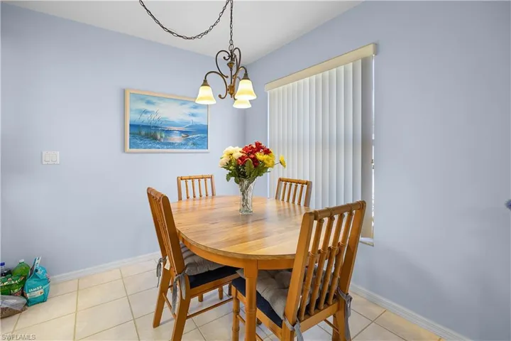 Dining space with a chandelier and light tile patterned floors