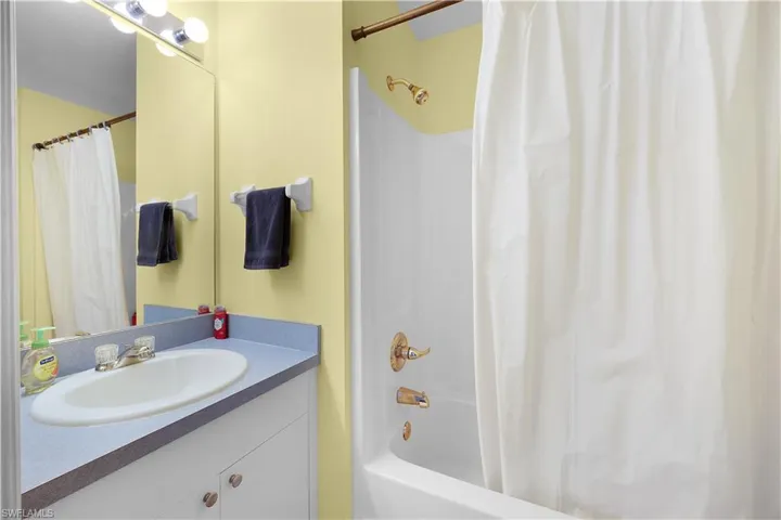 Full bathroom featuring vanity and shower / tub combo with curtain
