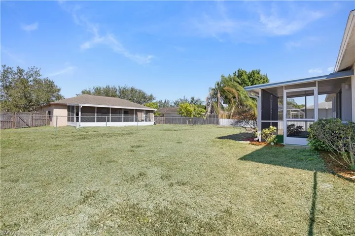 Fenced backyard with a sunroom