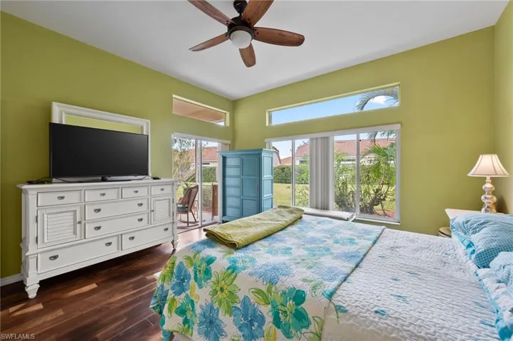 Bedroom with ceiling fan and dark hardwood / wood-style flooring