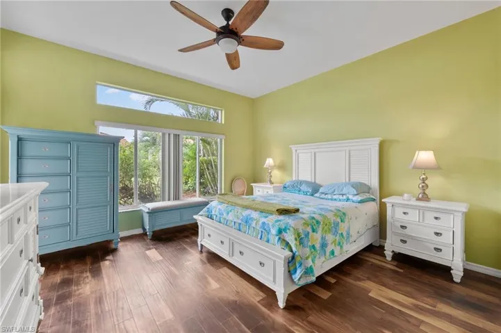 Bedroom featuring dark wood-type flooring and ceiling fan