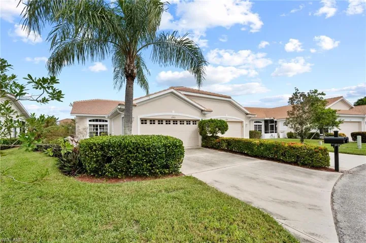 View of front of house featuring a front yard and a garage
