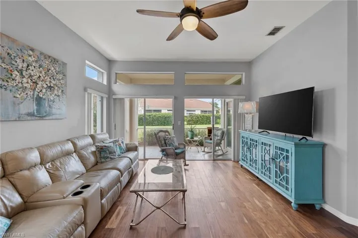Living room featuring hardwood / wood-style flooring and ceiling fan