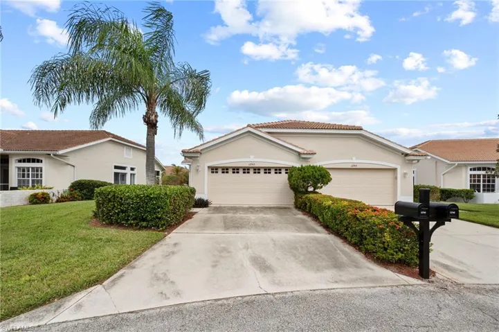 Ranch-style home with a garage and a front lawn