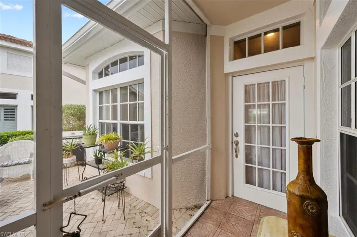 Doorway to outside with lofted ceiling with beams