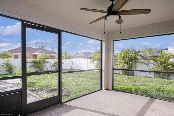 Unfurnished sunroom with a ceiling fan