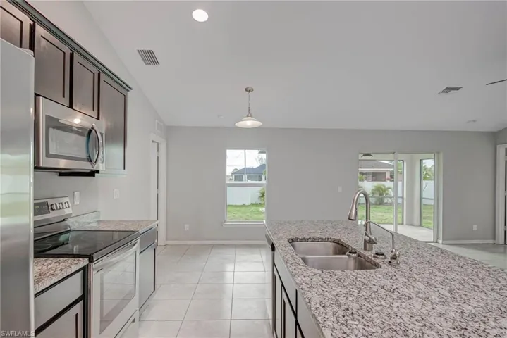 Kitchen with visible vents, a healthy amount of sunlight, stainless steel appliances, and a sink