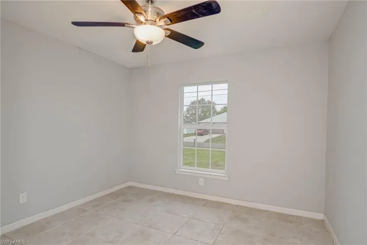 Spare room with baseboards and ceiling fan