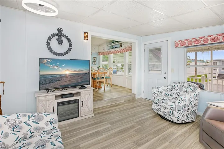 Wood-finish flooring throughout, with light-colored wall paneling and a white ceiling