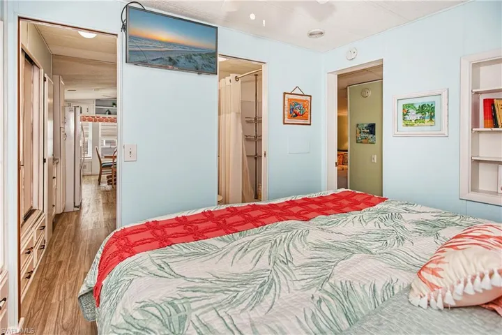 Built-in shelving, wood-finish flooring, and light blue wall panels