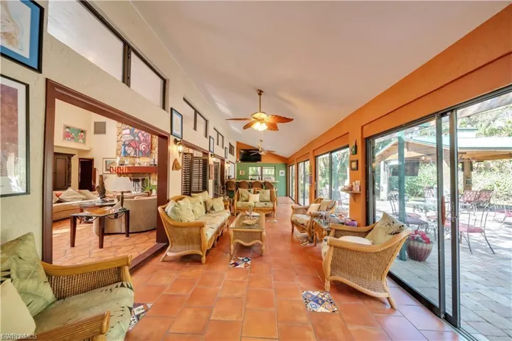 Tiled flooring in a sunroom with multiple sliding glass doors and transom windows