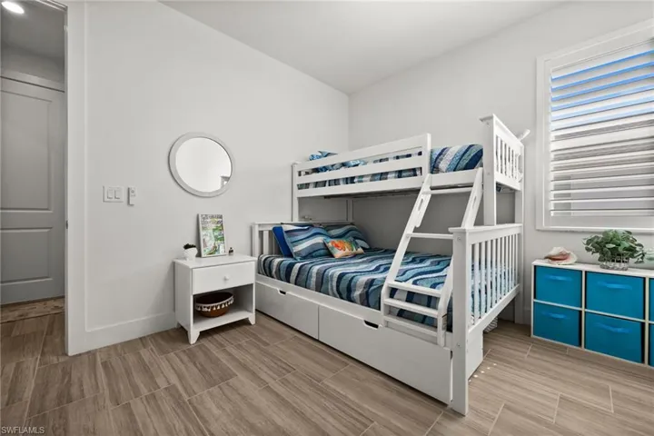 Bedroom with baseboards and wood finish floors