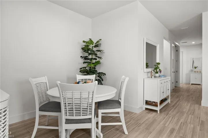 Dining space with light wood-style floors, baseboards, and recessed lighting