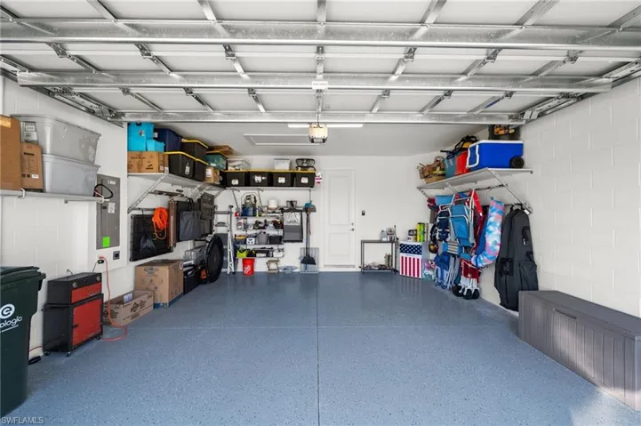 Garage with a garage door opener and epoxy flooring
