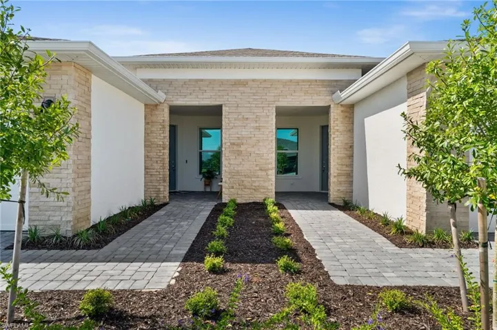 Property entrance featuring brick siding