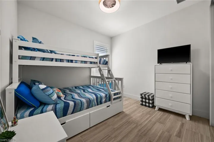 Bedroom with wood finished floors and baseboards