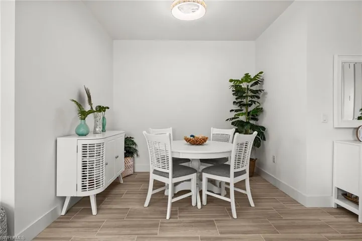 Dining area featuring baseboards and wood tiled floor