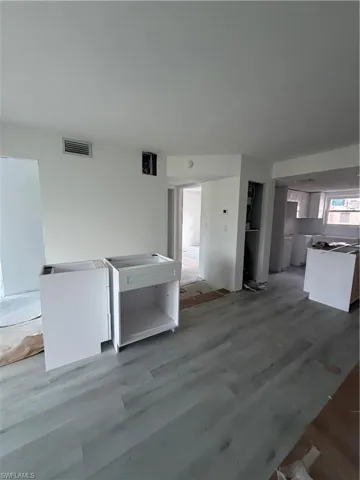 Unfurnished living room with wood finished floors