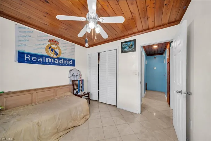 Bedroom featuring wood plank ceiling, recessed lighting, and a ceiling fan