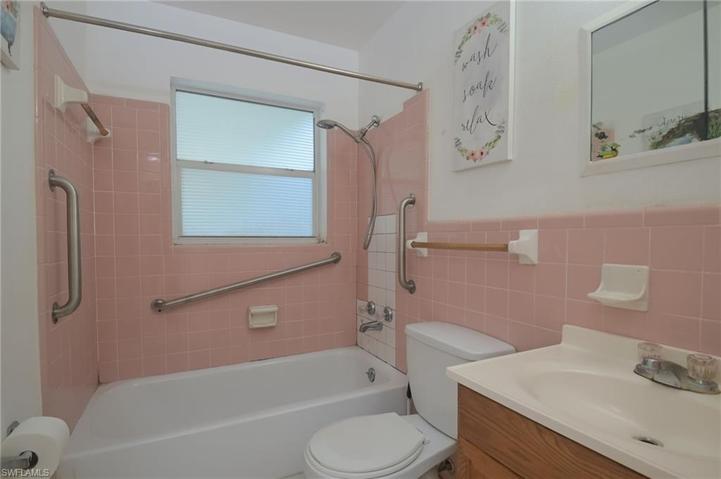 Guest bathroom is handicapped equipped and has full tub, shower, vanity w/cabinet and medicine chest.