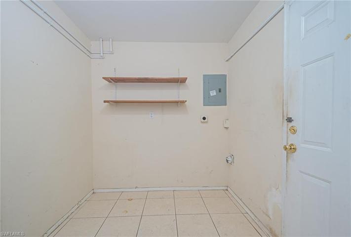 Laundry room with lots of storage and newer water heater and 2 doors to backyard.