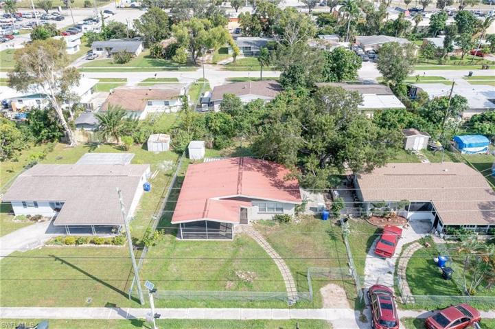 Aerial shot of showing big yard with lots of trees.