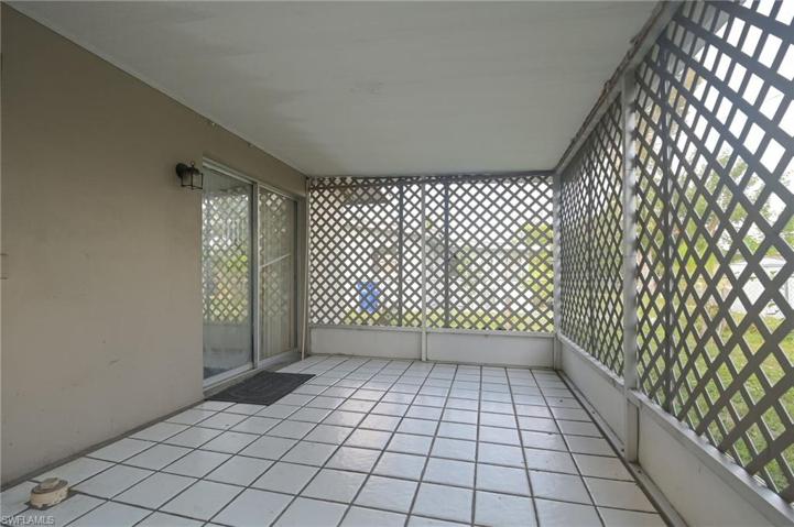 Tiled backyard screened lanai adjoins second bedroom.