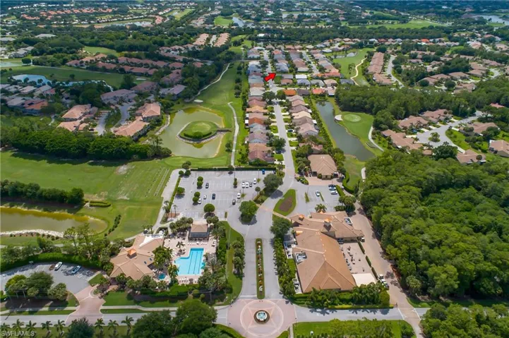 View of property location featuring a nearby body of water, a local golf course, and nearby suburban area